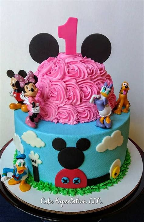 A Mickey Mouse Birthday Cake With Pink Frosting