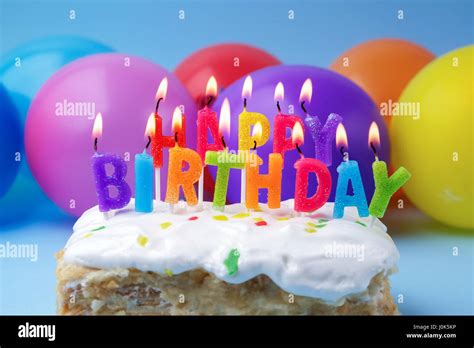 Cake With Birthday Greetings From Burning Candles On A Colored Balloons