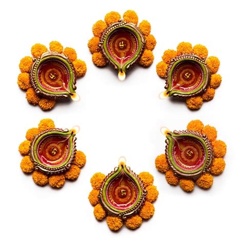 Premium Photo | Happy diwali rangoli made using diya and flowers, card