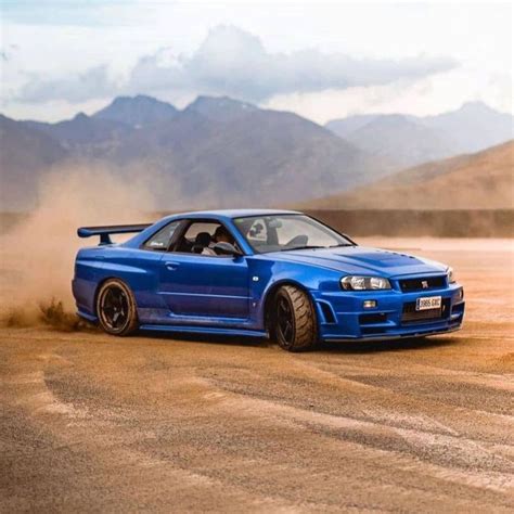 Blue Nissan Skyline GTR on a Dirt Road