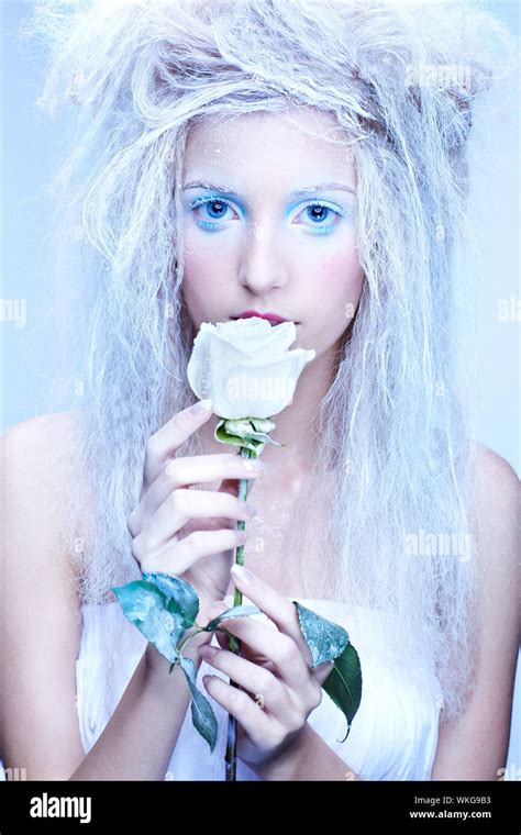 Close Up Portrait Of Beautiful Blonde Frozen Fairy Nymph Girl With White Rose Stock Photo Alamy