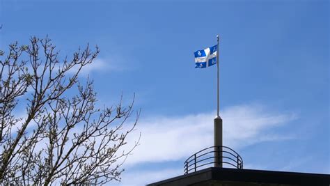 Montreal City Flag And The Quebec Provincial Flag Blowing On Flagpoles ...