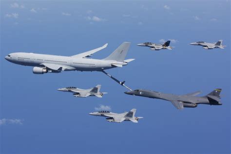 A RAAF KC-30 refueling a B-1 Lancer surrounded by Super Hornets : r ...