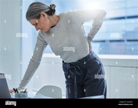 Wheres The Chiropractor When You Need One Shot Of A Mature Businesswoman Standing Alone In The