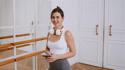 Premium Photo Active Brunette Brazilian Girl In Headphones Sportswear Standing At Gym Dance