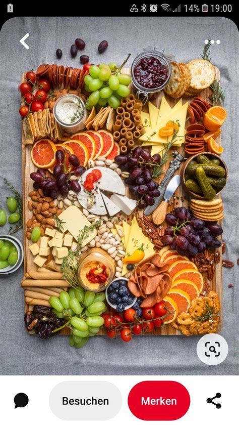 An Assortment Of Cheeses Fruits And Crackers On A Platter