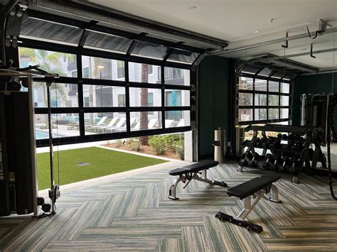 Glass Garage Door Unites Fitness Room And Pool At This Tampa Community