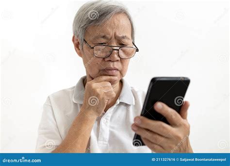 Confused Asian Senior Woman With Puzzled Looks Holding Smartphone