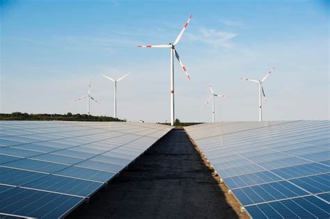 Premium Photo Windmill And Solar Panels On A Blue Sky