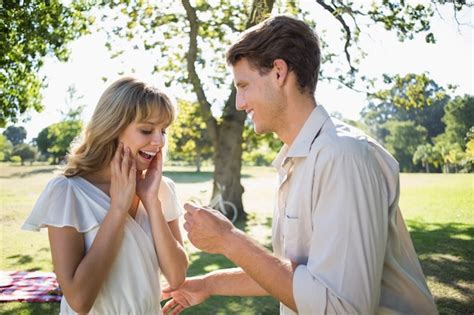 Premium Photo Man Surprising His Girlfriend With A Proposal In The Park