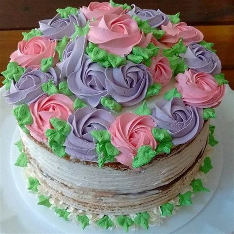 There Is A Cake That Has Pink And Purple Flowers On It