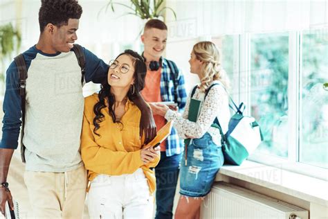 Young Happy Students Spending Time In College Hall Together Stock