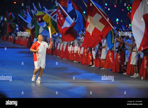 Gymnast Li Ning carries the torch to light the Olympic Flame during the ...