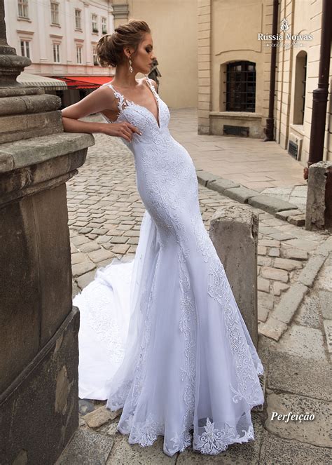 A Woman In A Wedding Dress Leaning Against A Stone Wall On A