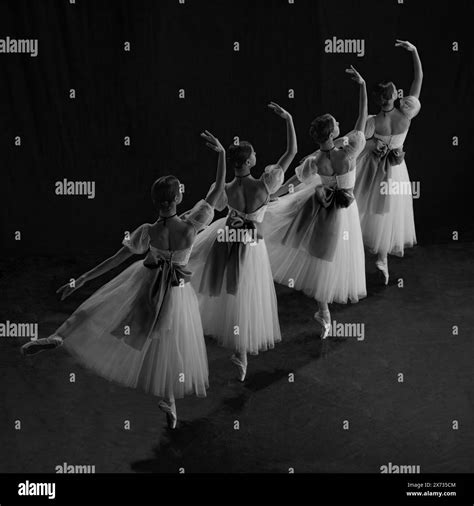 Ballerinas Elegantly Performing On Stage Dresses Flowing Gracefully As