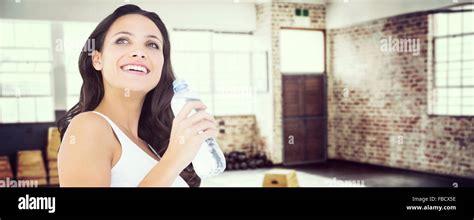 Composite Image Of Pretty Brunette Drinking Bottle Of Water Stock Photo Alamy