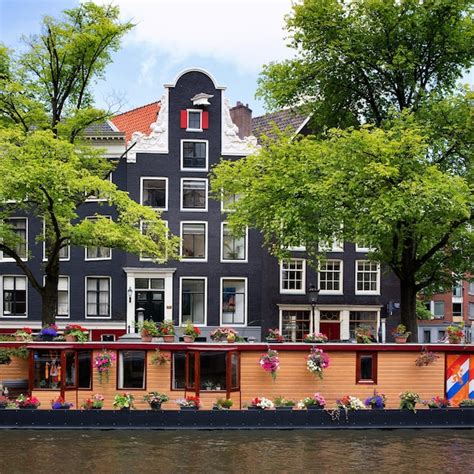 Premium Photo | Amsterdam canal with houseboat