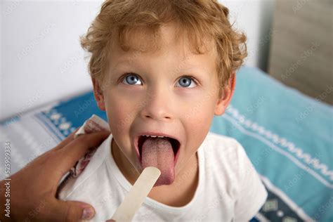 Close Up Face Child With His Mouth Wide Open And Sticking Out His