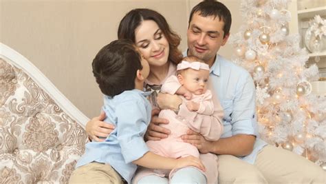 Same Sex Couple Sleeping On Their Sofa With Their Baby Son Sleeping On