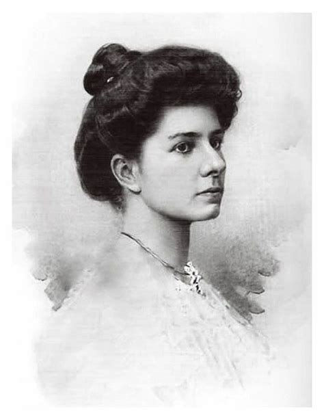 An Old Black And White Photo Of A Woman With A Bun In Her Hair