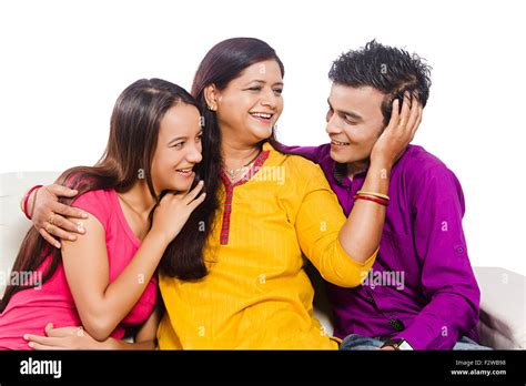 3 indian mother young Daughter and son sitting home Caring Stock Photo