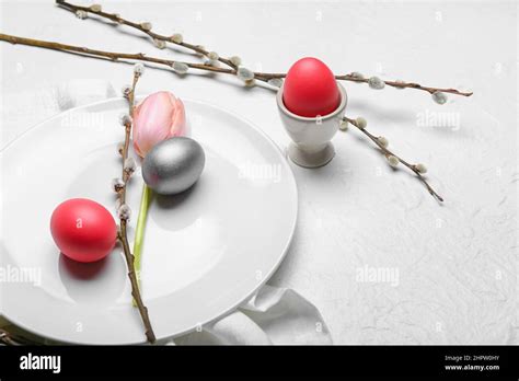 Plate With Painted Easter Eggs Tulip Flower And Pussy Willow Branches On Light Background Stock