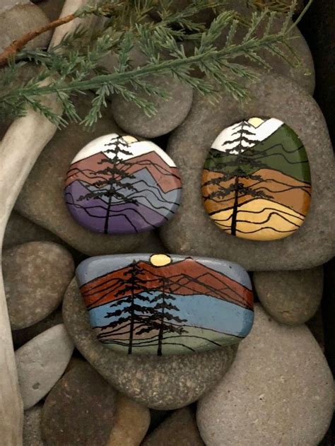 Three Rocks With Trees Painted On Them