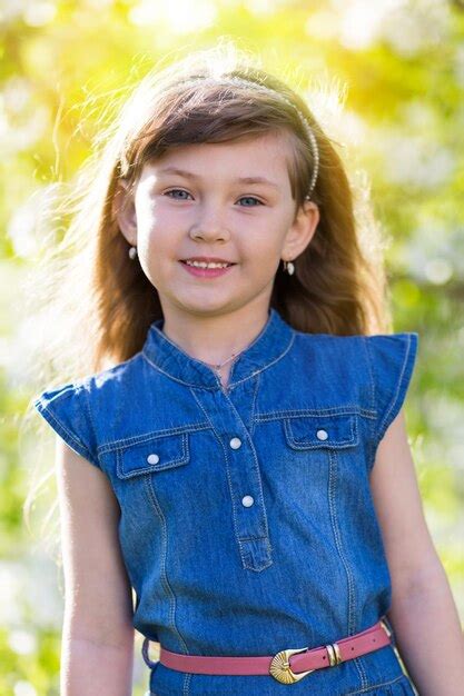 Premium Photo Portrait Of Smiling Girl Standing Outdoors