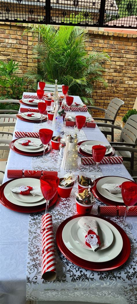 The Table Is Set With Red And White Dishes