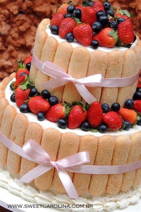 Two Tiered Cake With Strawberries And Blueberries On Top