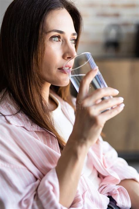 Brunette Woman Drinking Water In The Living Room Stock Photo Image Of Brunette Adult 182731652