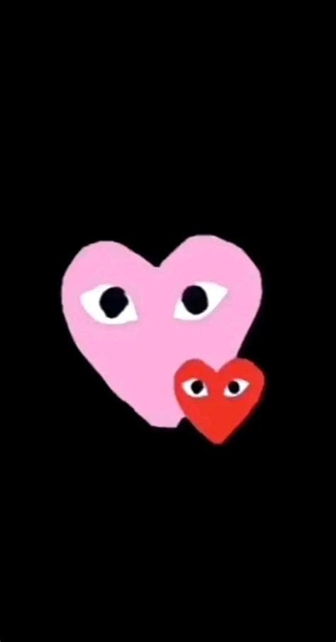 Two Hearts With Eyes Are In The Middle Of A Black Background One Is Pink And The Other Is Red