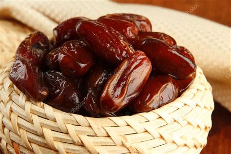 Dried dates in basket on table close up Stock Photo by ©belchonock 35207661