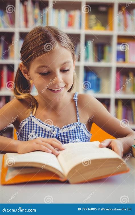 Smiling School Girl Reading a Book in Library Stock Image - Image of ...