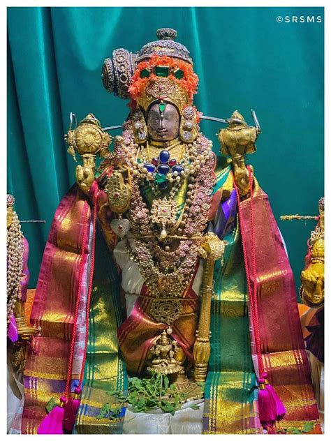 An Idol Is Displayed In Front Of A Blue Curtain