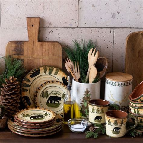 There Are Many Dishes And Utensils On The Table With Pine Cones In Them