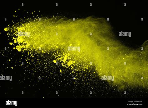 Abstract of yellow powder explosion on black background. Yellow powder ...