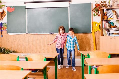 Premium Photo | Two best friends hugging and fun smiling in classroom