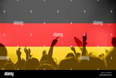 Crowd Of Football Soccer Fans With Raised Arms With Blending Germany