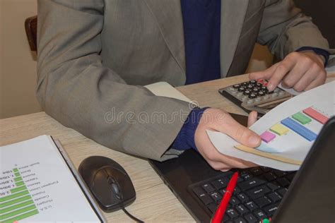 Businessman Using A Calculator To Calculate The Numbers Businessman