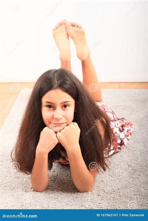 Barefoot Girl Lying On Carpet Royalty-Free Stock Photo | CartoonDealer ...