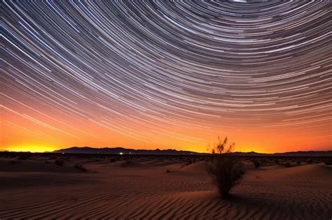 Premium AI Image | Timelapse of star trails above desert sand dunes ...