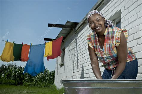 Woman Hand Washing Clothing Outside Her Rural Home Stock Image F033