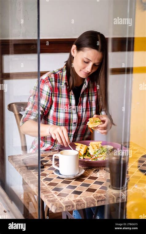 Brunette Woman Having Breakfast Alone In Cafe Stock Photo Alamy