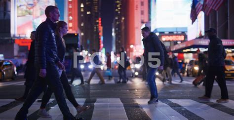 People Walking On The Street At Night