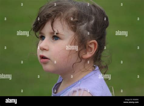 Little Girl With Brown Hair And Blue Eyes