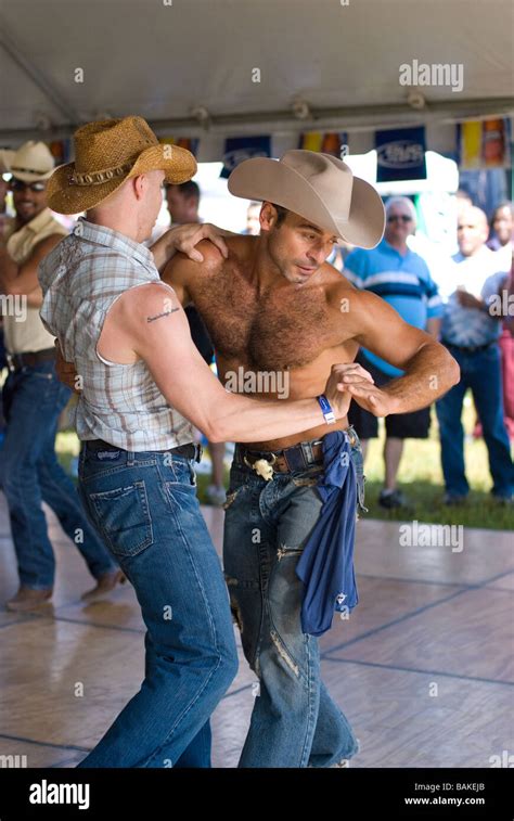 Gay Couple Dancing To Country And Western Music At Rodeo Event Stock