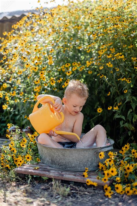 Beautiful Blonde Washes Herself In Basin In Fresh Air Douses Herself With Water Stock Photo