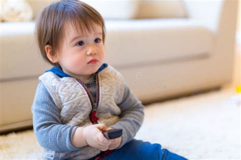 Toddler Boy Watching TV with a Remote Control Stock Photo - Image of ...