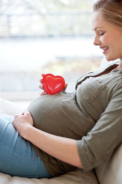 Pregnant Woman With Heart Shape On Tummy Photograph By Ian Hooton